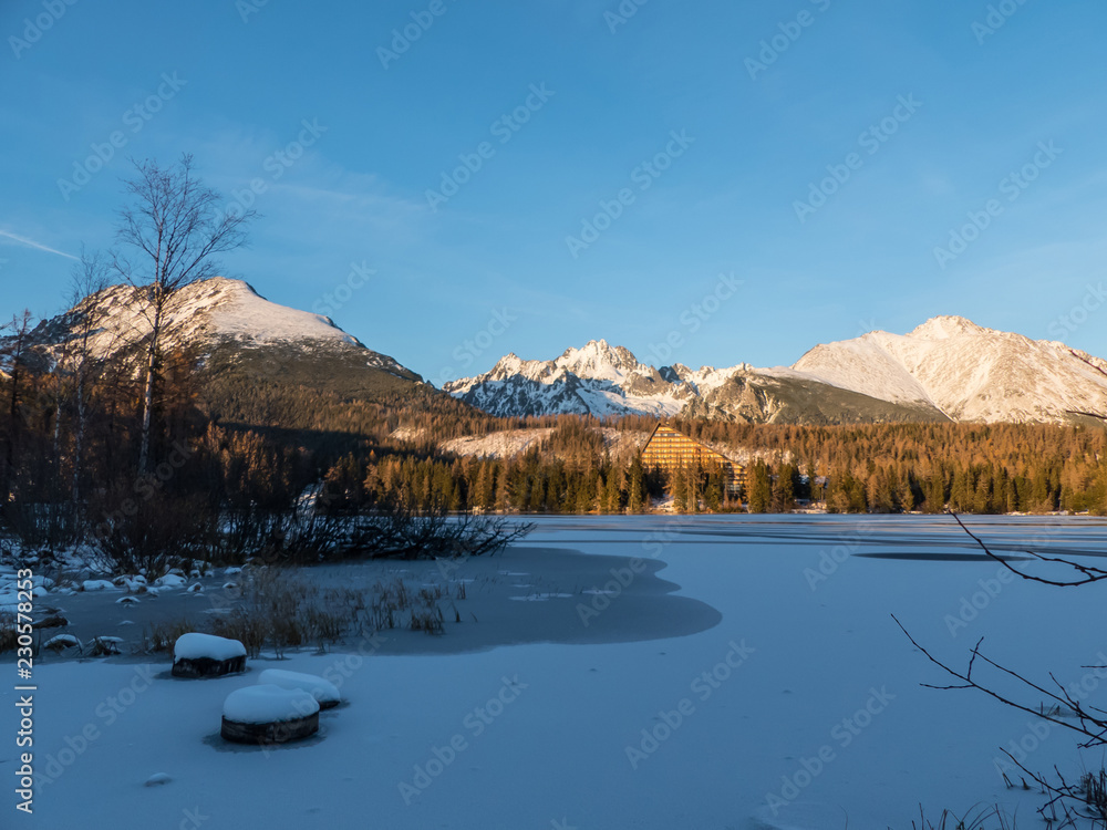 Sunset in Hight Tatras. Evening in winter mountains. Evening by the lake Strbske Pleso. Evening, sunset, mountains and winter.