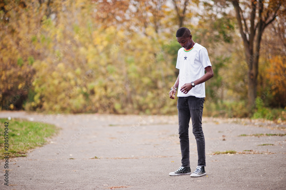 African man in white football sport t-shirt of Ghana Africa country. African man in white football sport t-shirt of Ghana Africa country.