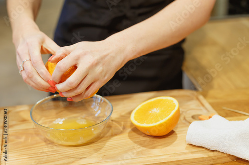 close-up scene of squeezing oranges on kitchen selective focus