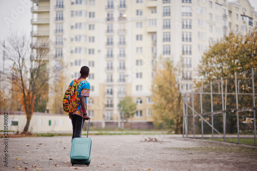 Quadro em tela African man in africa traditional shirt on autumn park with backpack and suitcase