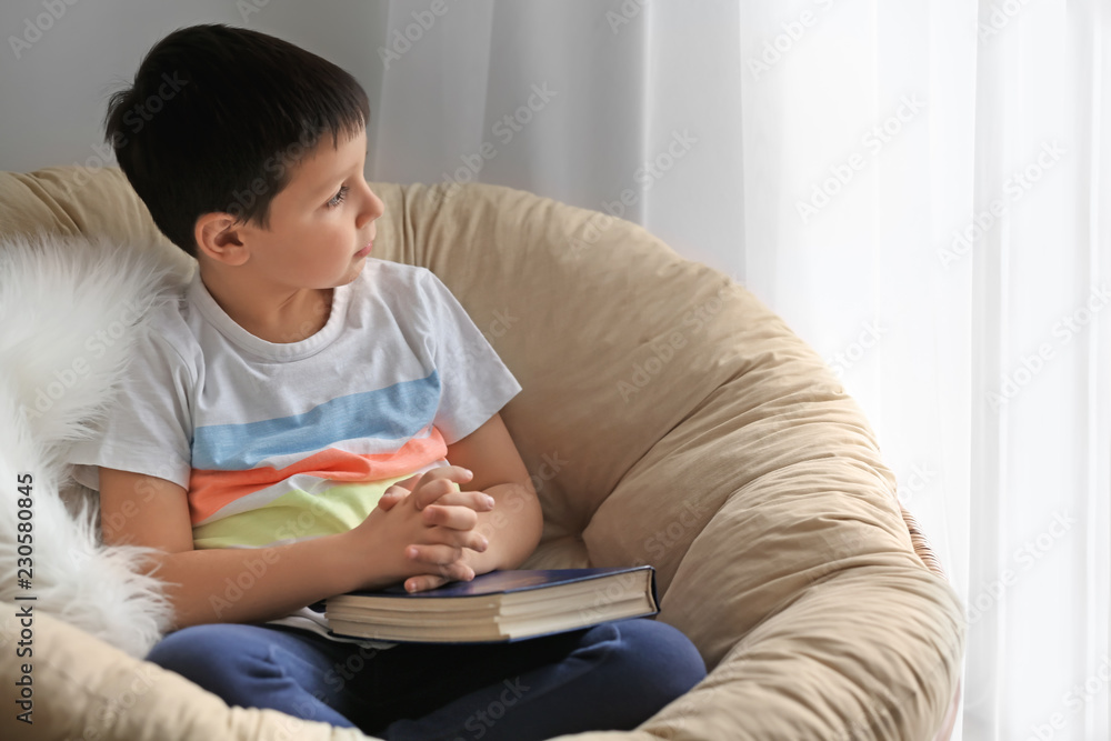 Little boy with Bible at home Little boy with Bible at home