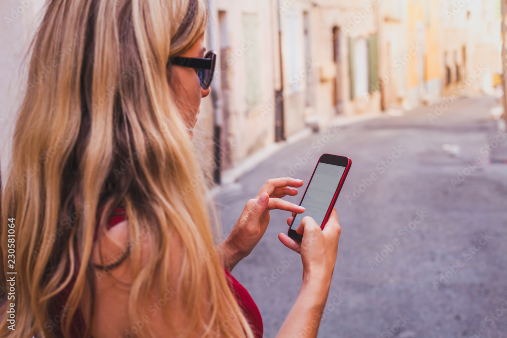 woman using smartphone on the street, mobile internet communication woman using smartphone on the street, mobile internet communication
