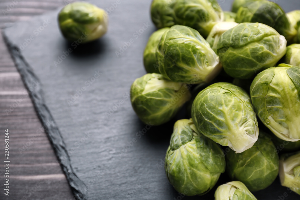 Fresh brussels sprouts on slate plate, closeup Fresh brussels sprouts on slate plate, closeup