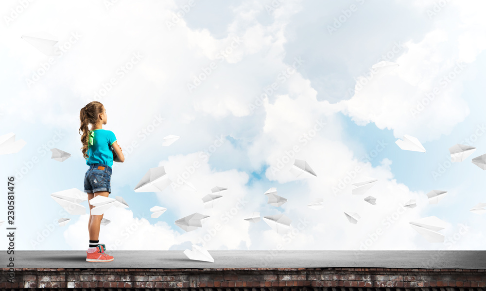 Concept of careless happy childhood with girl looking far away Concept of careless happy childhood with girl looking far away