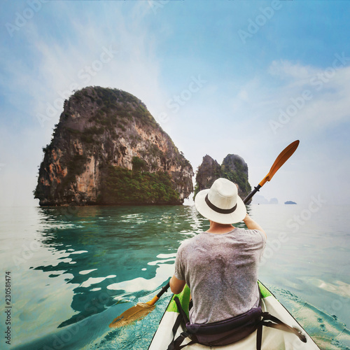 travel by kayak in Asia, beach holiday tourism activity, man tourist kayaking on tropical beach