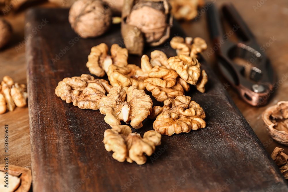 Shelled walnuts on wooden board, closeup Shelled walnuts on wooden board, closeup