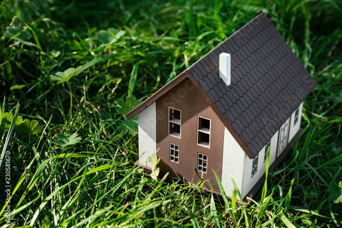 Model of house on green gra...