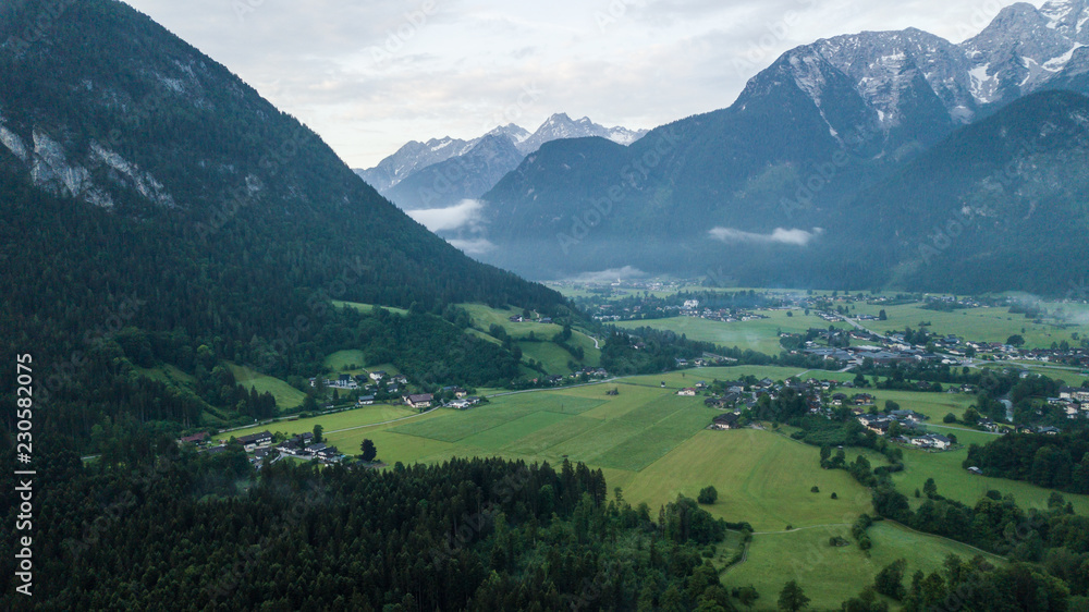 Obraz premium Aerial view of the morning foggy landscape in the alpine mountains