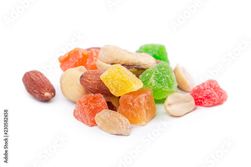 Pile of toasted nuts and candied fruit isolated on white background