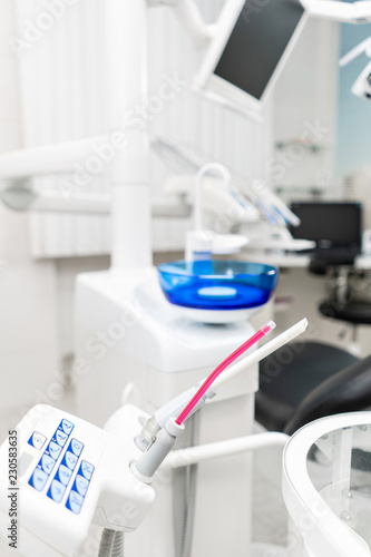 Stomatological instrument in the dentists clinic. Dental work in clinic. Operation  tooth replacement. Medicine  health  stomatology concept. Office where dentist conducts inspection and concludes.