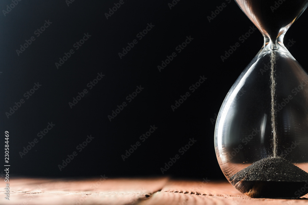 Modern hourglass on wooden background - obrazy, fototapety, plakaty 