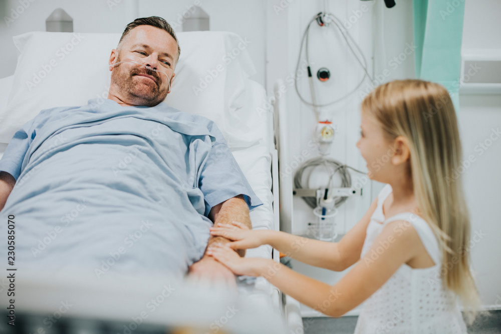 Obraz premium Daughter holding fathers hand in the hospital