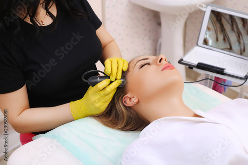 Woman visiting dermatologist at clinic.  photo