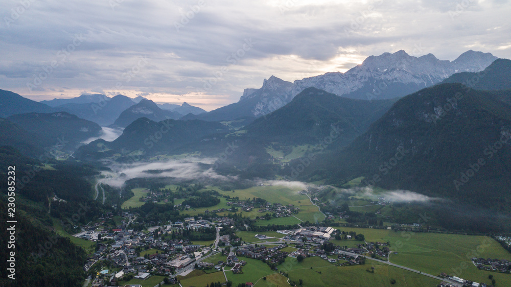 Aerial view of the morning foggy landscape in the alpine mountains