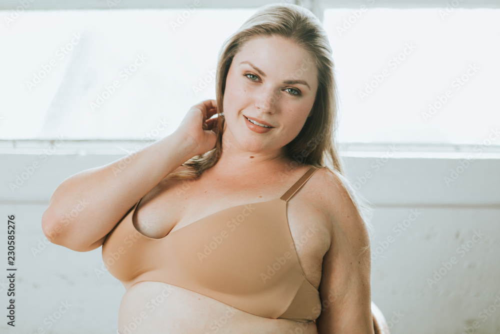 Foto de Beautiful and confident plus size woman in nude underwear do Stock