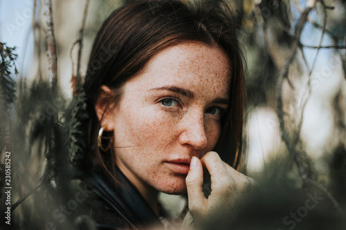 Portrait of a young woman with freckles photo