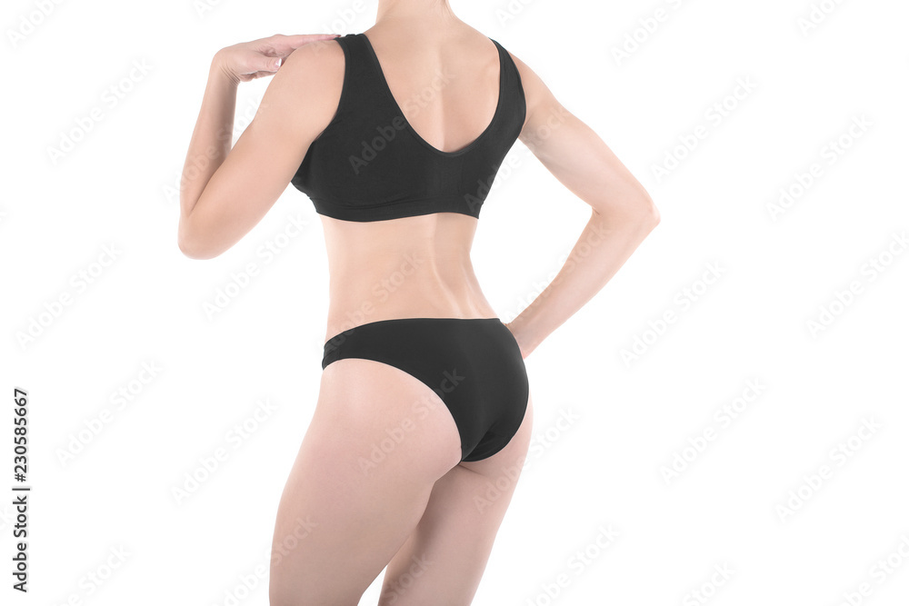 Female cropped fit back and buttocks in black panties and top, isolated on white. Female cropped fit back and buttocks in black panties and top, isolated on white.