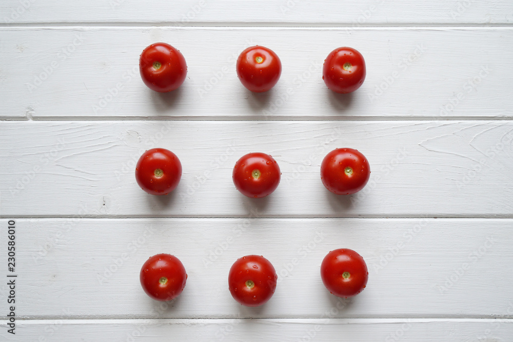 top view of cherry tomato flat lay on white wooden background