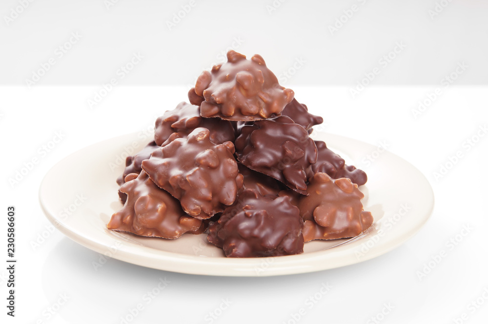 nut chocolates piled on plate with selective focus nut chocolates piled on plate with selective focus