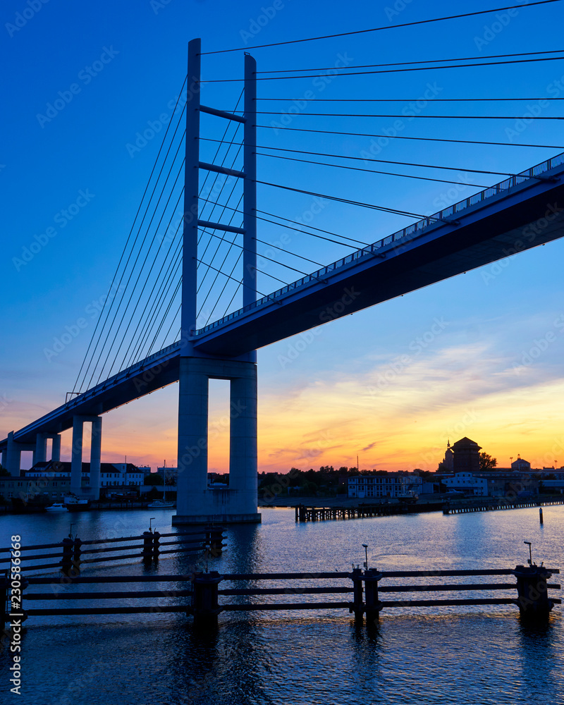 Bridge to the island Rügen with sunset and blue sky. Germany