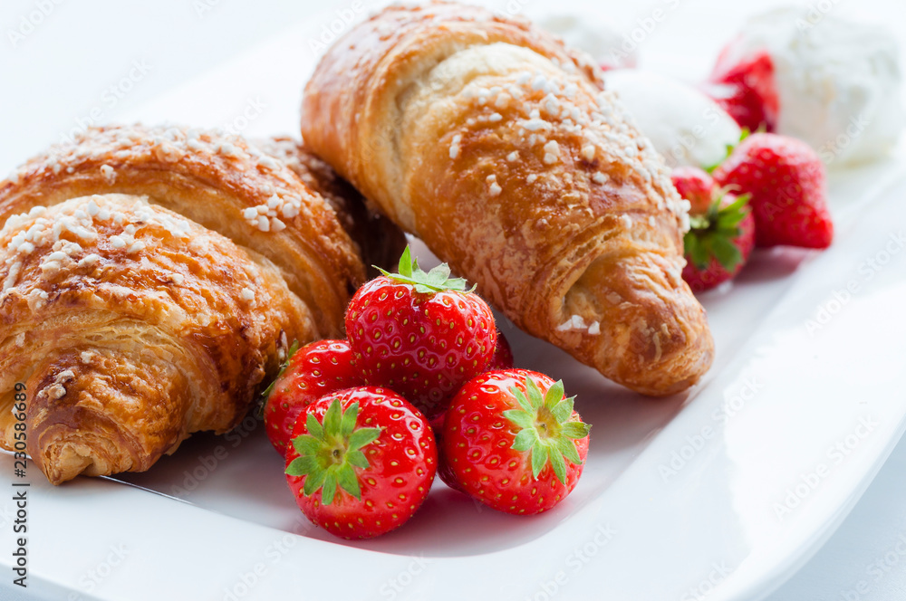 Decorated food. Croissants with strawberries and ice cream dessert Decorated food. Croissants with strawberries and ice cream dessert