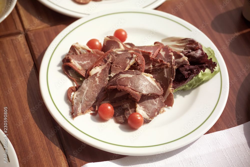 close up plate of sliced pastrami arrangement on breakfast table close up plate of sliced pastrami arrangement on breakfast table