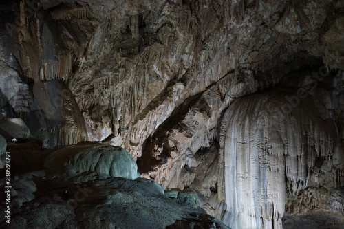 Underground caves of Abkhazia. Stalactites and stalagmites in the dark.