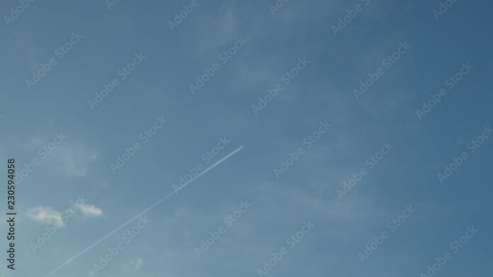 Engine exhaust contrails forming behind an jet plane Engine exhaust contrails forming behind an jet plane