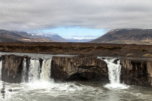 Water of the Godafoss Waterfall - beautiful part of stony rocky desert landscape of Iceland. Toned.