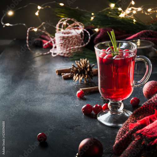 Christmas cranberry mulled wine garnish rosemary and fir branches on black. Xmas drink.