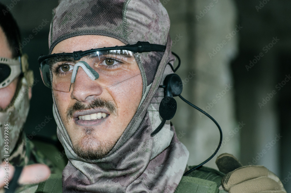 Obraz premium Airsoft soldier with trasmiter microphone communication, full faces mask gloves