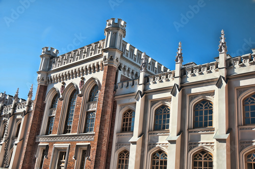 Gothic facades of a huge, trapezoid building of former court stables. The building, made in the form of a medieval fortress in the style of English Gothic photo