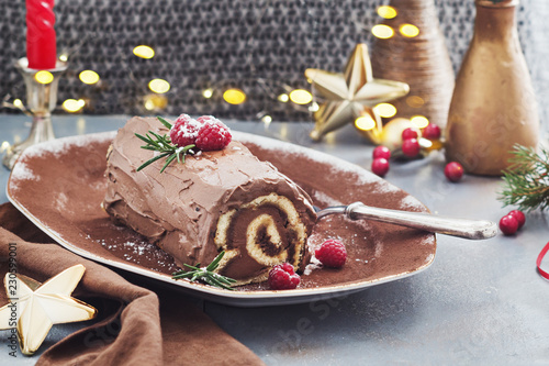Obraz na płótnie Chocolate yule log Christmas cake with  raspberries.