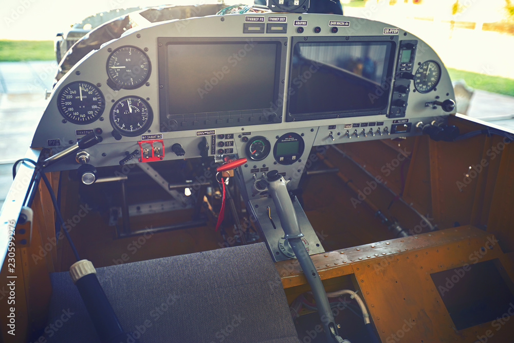 View of the cockpit and control levers of a single-engine aircraft parked. View of the cockpit and control levers of a single-engine aircraft parked.