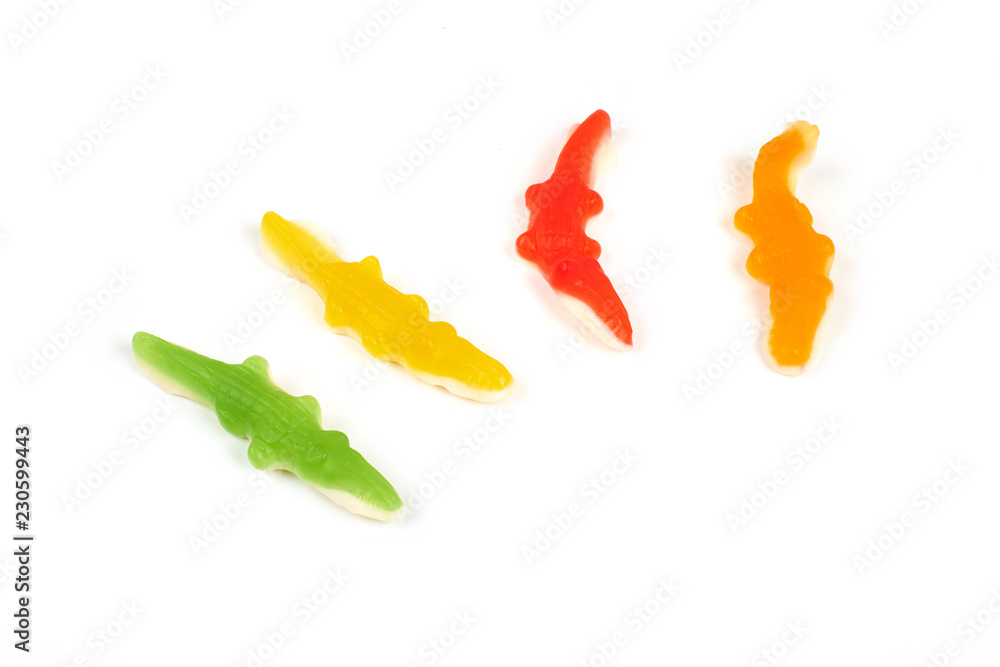 jelly candies in the crocodile shape isolated on white background. jelly candies in the crocodile shape isolated on white background.