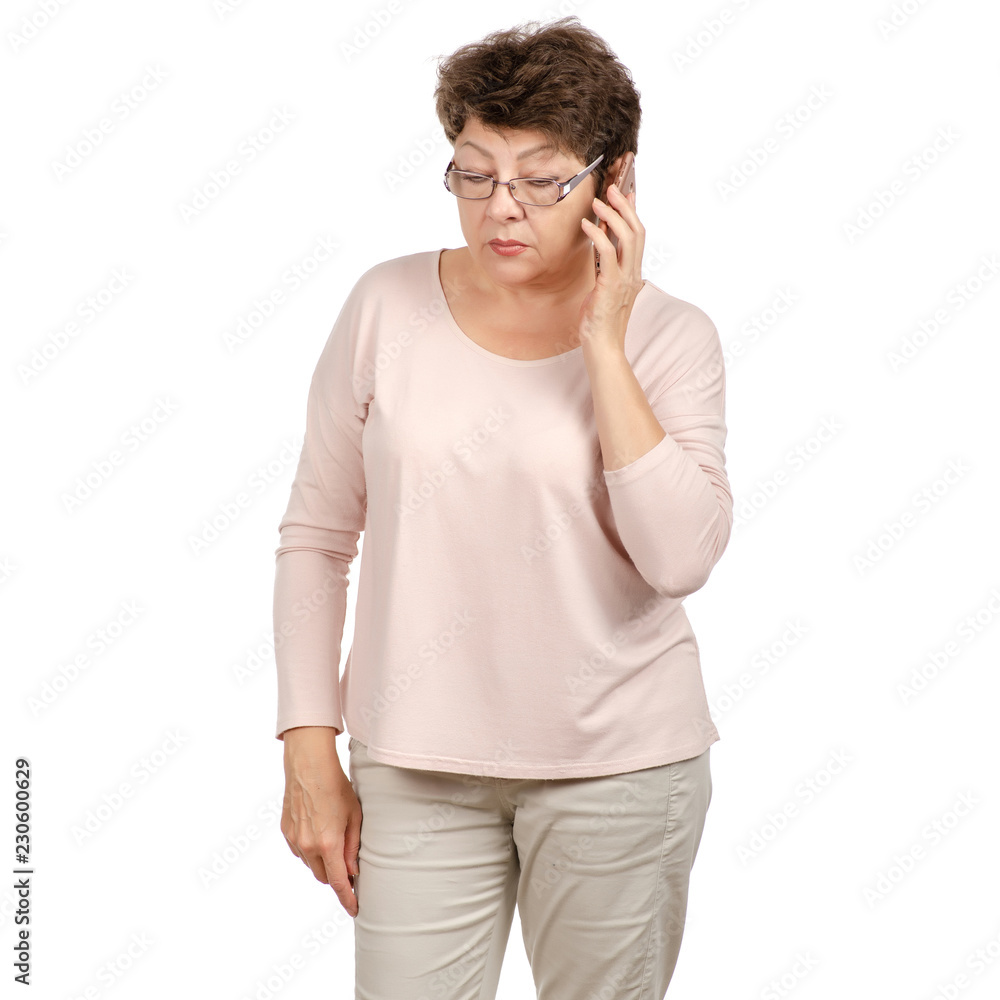 Beautiful woman aged with glasses in the hands of a mobile phone talking on a white background. Isolation Beautiful woman aged with glasses in the hands of a mobile phone talking on a white background. Isolation