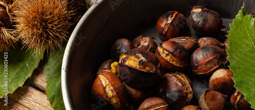 Roasted chestnuts in iron skillet photo