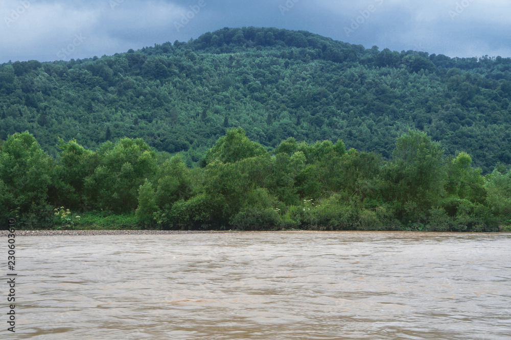 Beautiful mountain river in cloudy weather in the European Chati world. The flood of rain. Stock photo for design