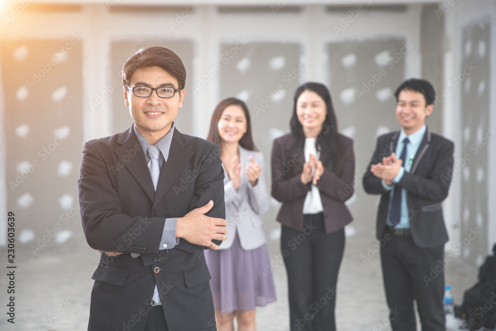 businessman portrait with employee clapping hands as background businessman portrait with employee clapping hands as background