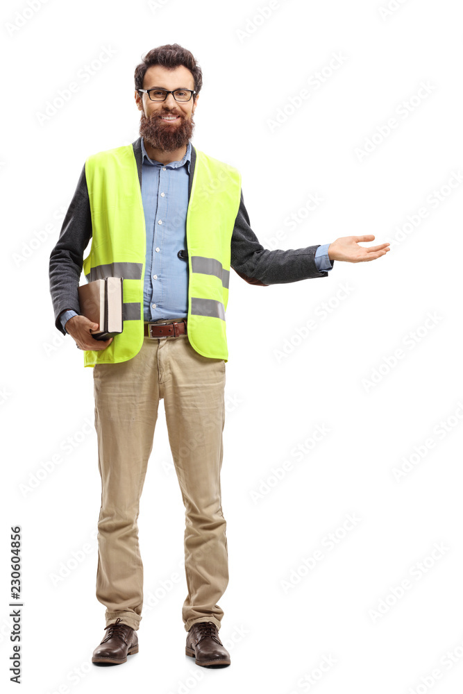 Bearded man holding books, wearing safety vest and gesturing welcome with hand