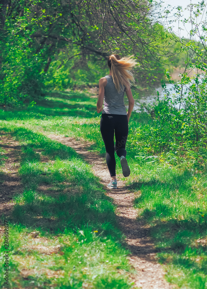 Young girl running at the forest happy