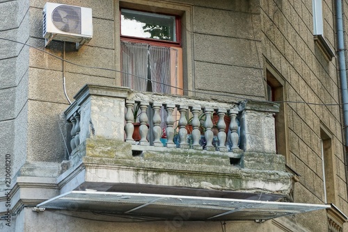 old gray concrete balcony on the wall with windows