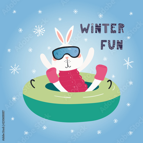 Hand drawn vector illustration of a cute funny bunny snow tubing outdoors in winter, with text Winter fun. Isolated objects on blue background. Scandinavian style flat design. Concept children print.