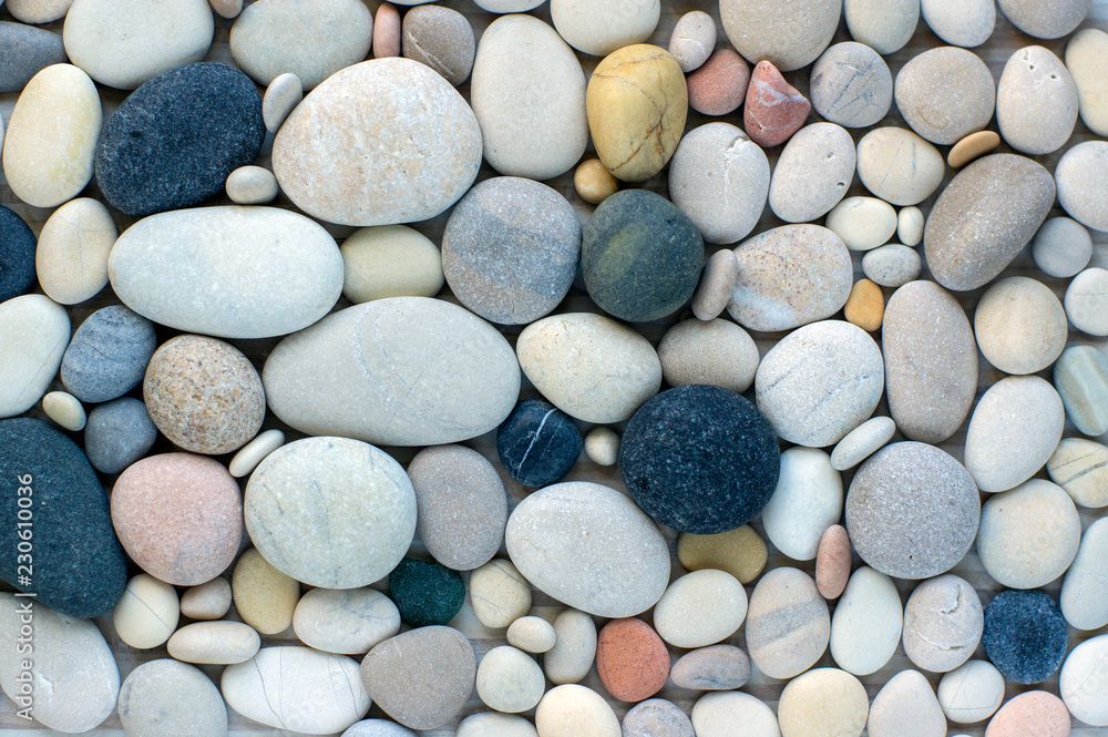 Group of white, grey and black pebbles, one by ony, simplicity stone background Group of white, grey and black pebbles, one by ony, simplicity stone background