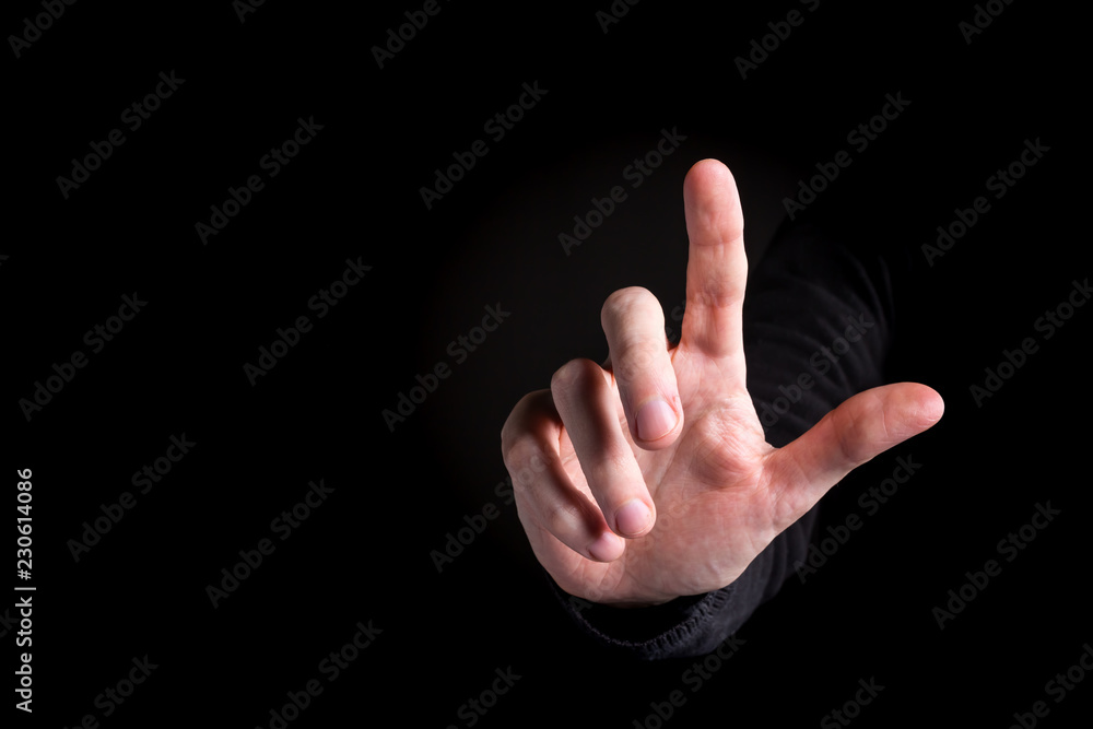Man pointing or pressing something on black background Man pointing or pressing something on black background