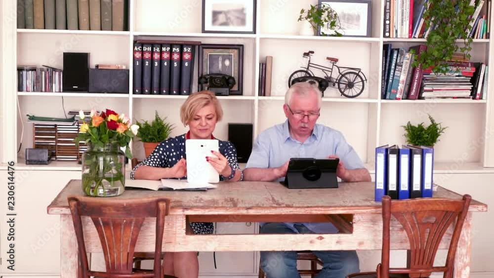 Senior, happy couple working with tablet by table at home
Senior, happy couple working with tablet by table at home
