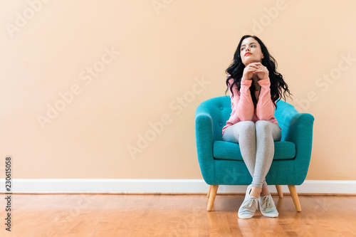 Portrait of a young woman in a chair