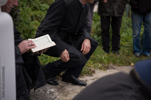 quran holy book reading by imam  on islamic funeral photo