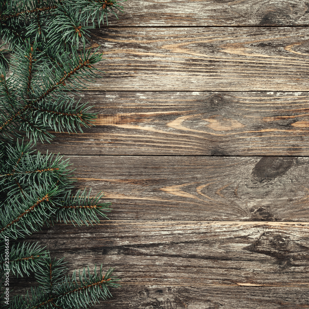 Old wood background with fir branches. Space for a greeting message. Christmas card. Top view. Xmas Square card. Old wood background with fir branches. Space for a greeting message. Christmas card. Top view. Xmas Square card.