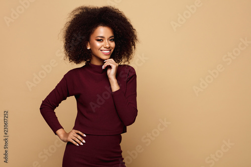 Happy black woman with an afro hairstyle and copy space looking at camera